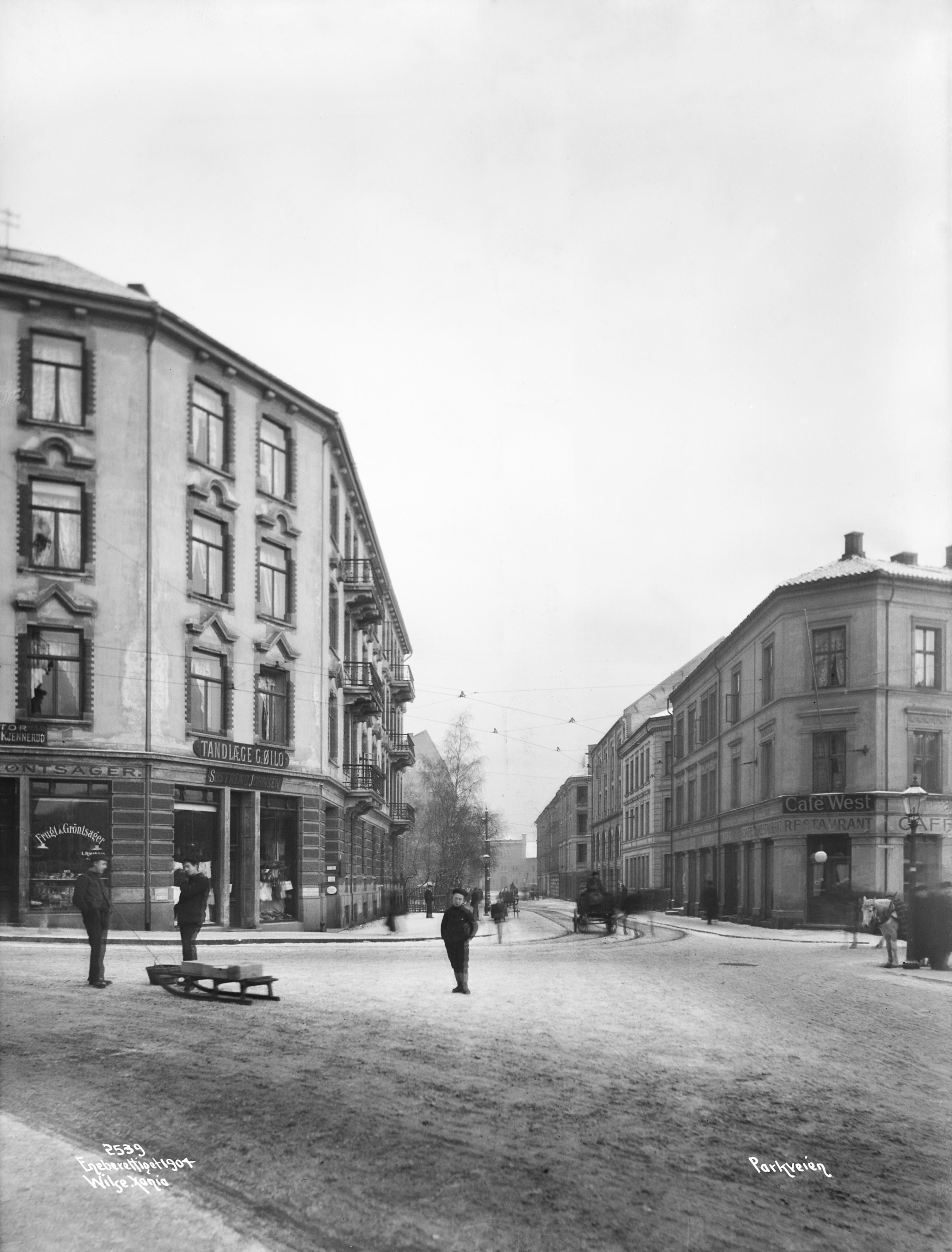 Parkveien in winter, with apartment buildings, shops, restaurants, people, sledges, horse-drawn carriages