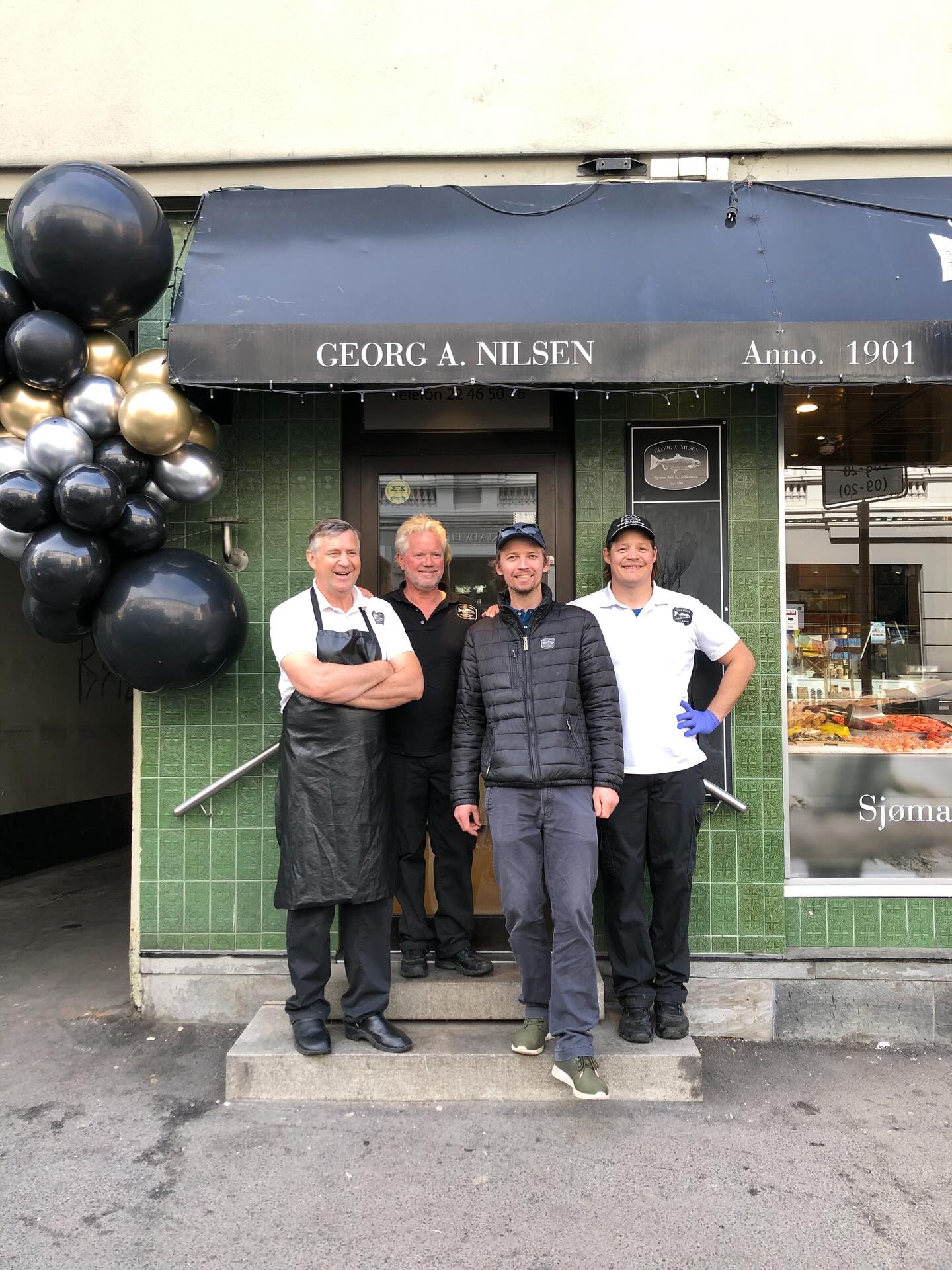 The owners of Georg A. Nilsen in front of the entrance to the store