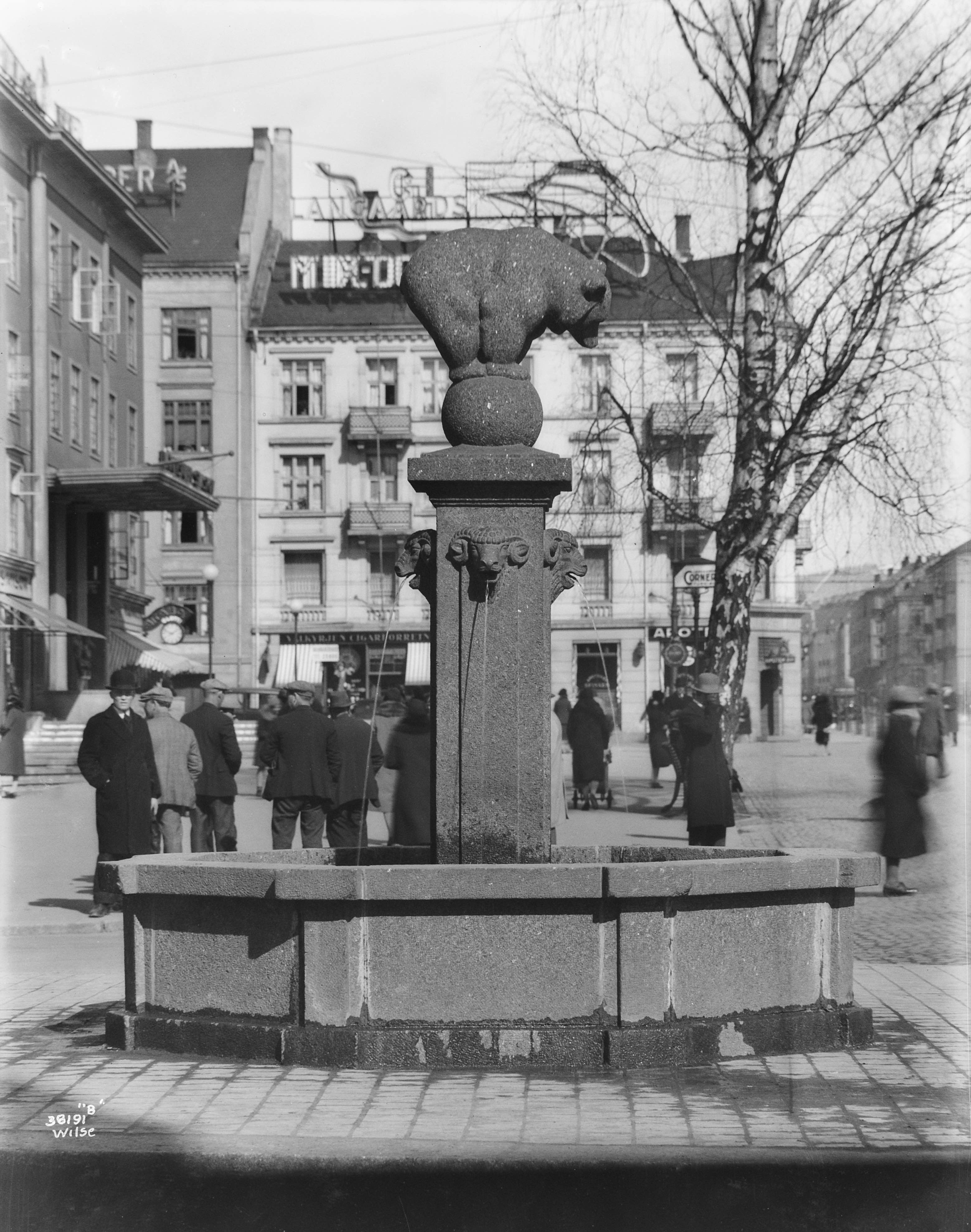 "The Bear Fountain" at Majorstuen with people standing in the background